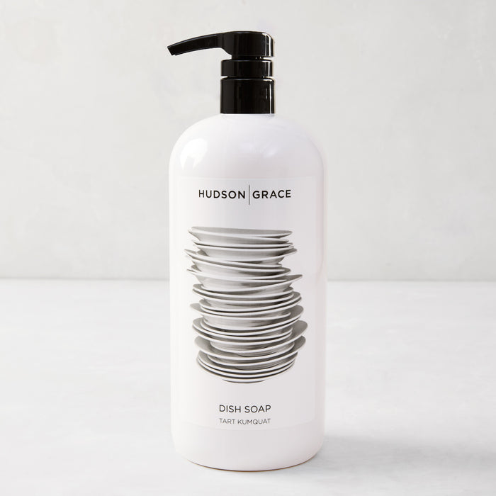 White HG Tart Kumquat Dish Soap bottle with a black pump, featuring a stack of plates design.