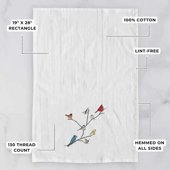 White towel with bird design on a gray background, featuring text about dimensions and material.
