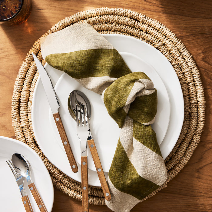 Teak Wood Bistro 5-Piece Flatware Set with stainless steel and laminated wood handles on white plates.