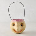Handcrafted papier-mâché turnip Halloween candy bucket with a distressed finish, smiling face, and black wire handle.