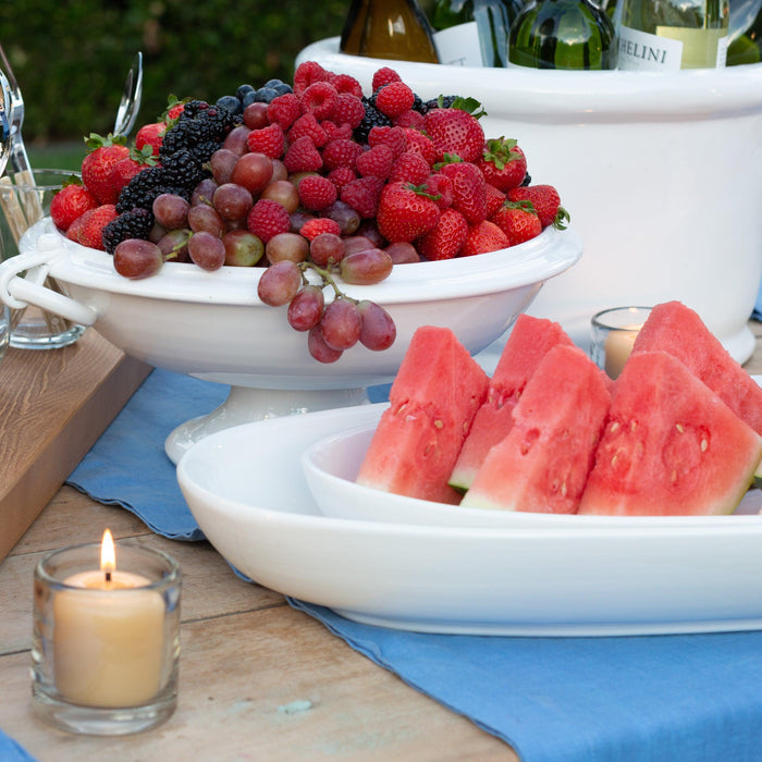 White ceramic oval serving platter with watermelon slices.