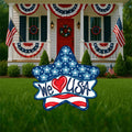 Patriotic star yard sign that says "We Love USA" Love is a heart, not the actual word. Red, white and blue colors. Summer holiday lawn signs and yard decor from Yard Art Decor and More. Made in the USA.