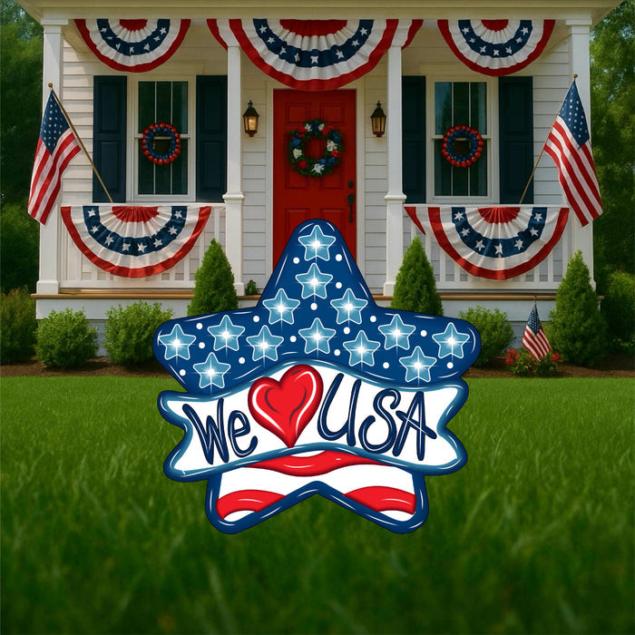 Patriotic star yard sign that says "We Love USA" Love is a heart, not the actual word. Red, white and blue colors. Summer holiday lawn signs and yard decor from Yard Art Decor and More. Made in the USA.