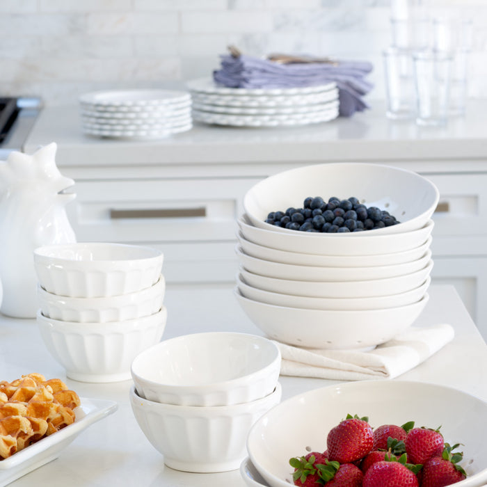 Stack of white ceramic latte bowls, 5.5" diameter, some filled with blueberries and strawberries.
