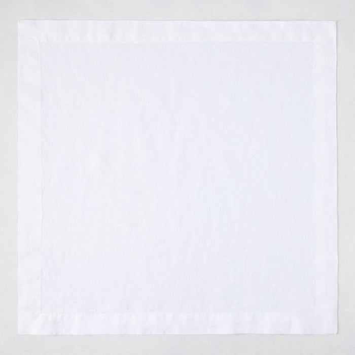 White HG Signature hand-dyed 22-inch square linen napkin with mitered corners.