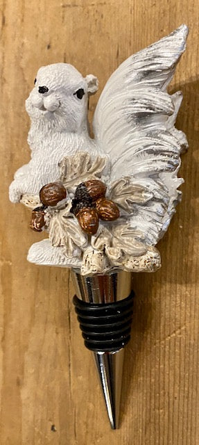 Resin white squirrel carrying some acorns, hand painted, atop a stainless steel wine bottle stopper.